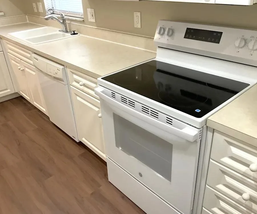Kitchen with new appliances and wood flooring