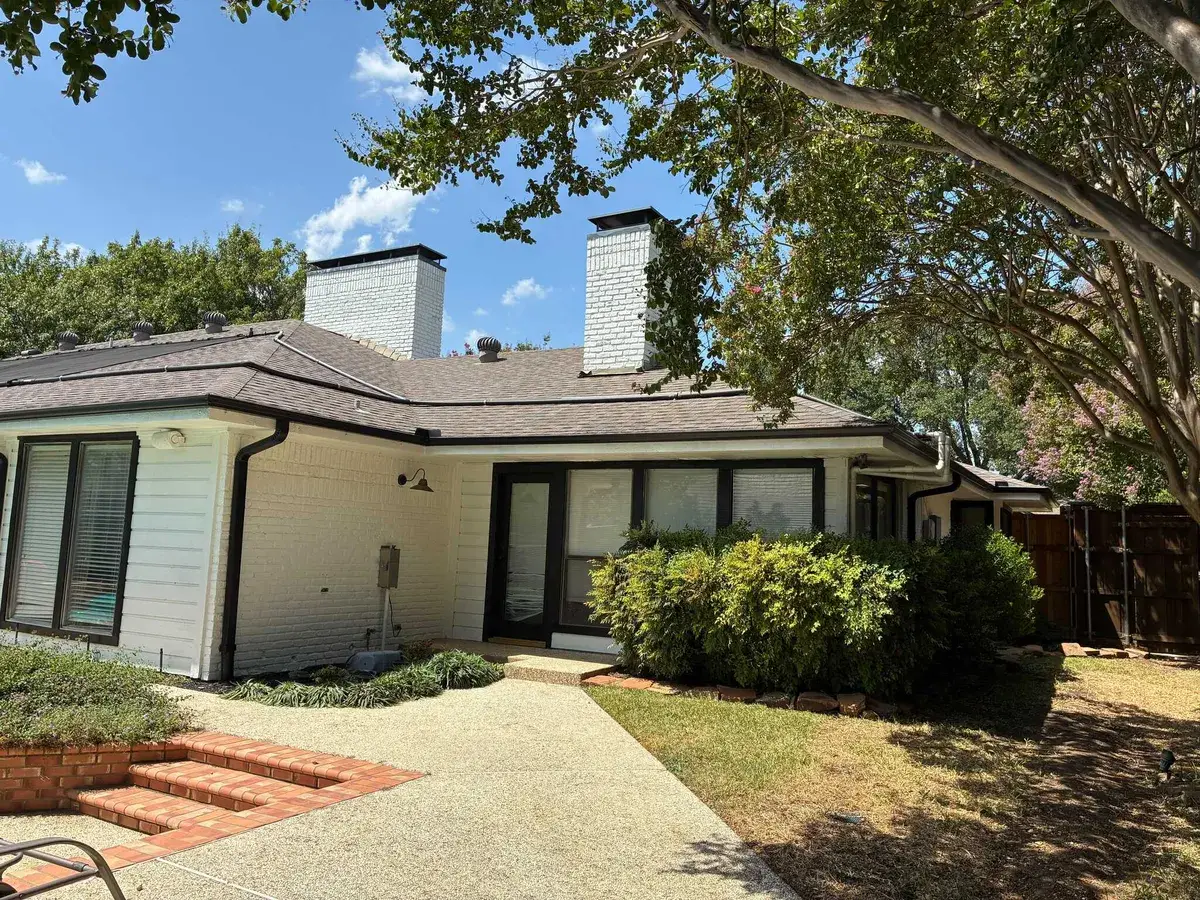 Freshly painted brick home exterior with new landscaping
